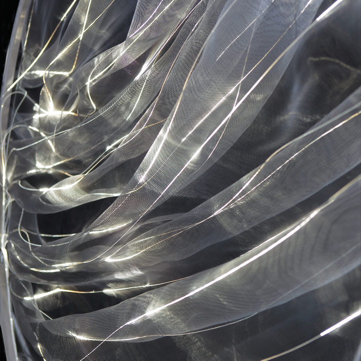 Light object made of fabric emits light into room through fibre optics